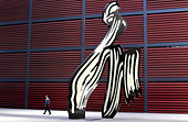 a-visitor-walks-past-a-sculpture-on-disp