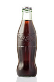 Fresh classic Coca Cola bottle isolated on white background - Stock Image